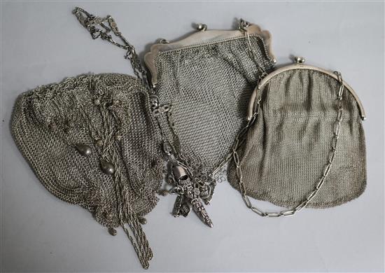 Three silver mesh evening bags and a silver whistle.